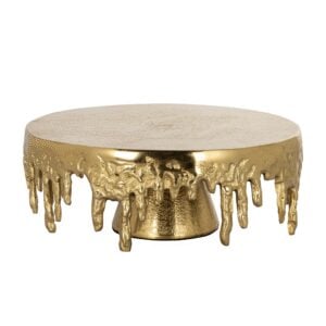 A gleaming gold coffee table with a teardrop-shaped base and a decorative melted effect, perfect for a luxurious interior.