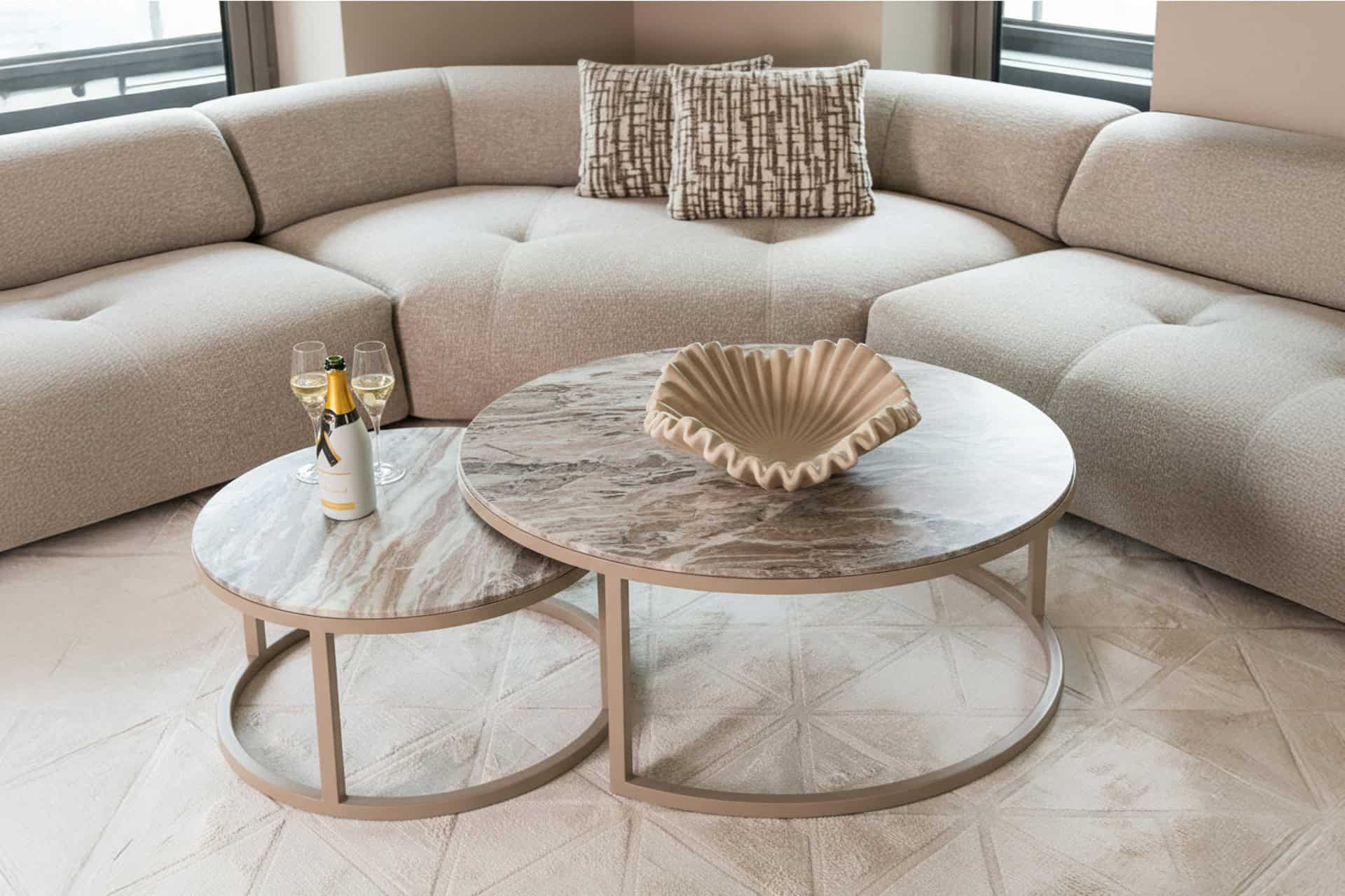 Un salon lumineux et chaleureux, avec des tables basses rondes, des accessoires raffinés et des canapés confortables.