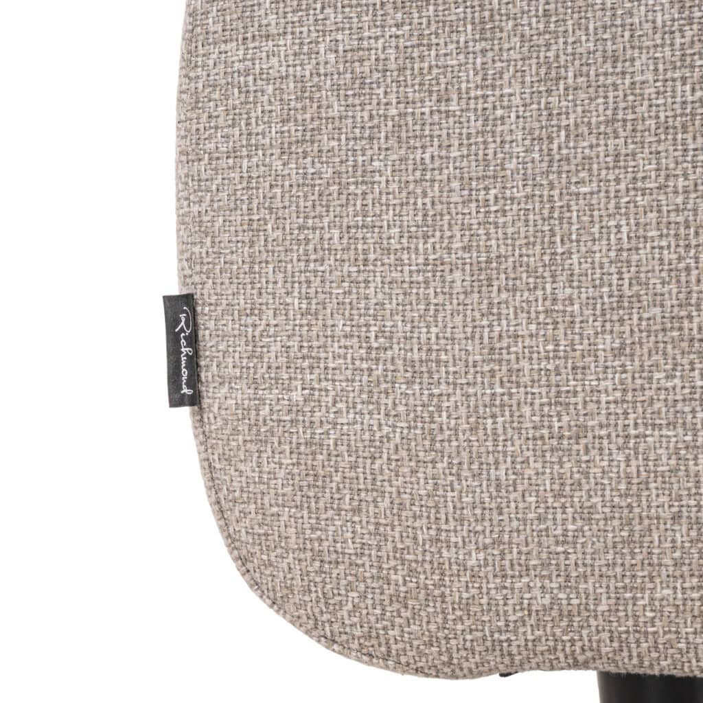 Beige textured armchair with fabric upholstery, perfect for contemporary living rooms.