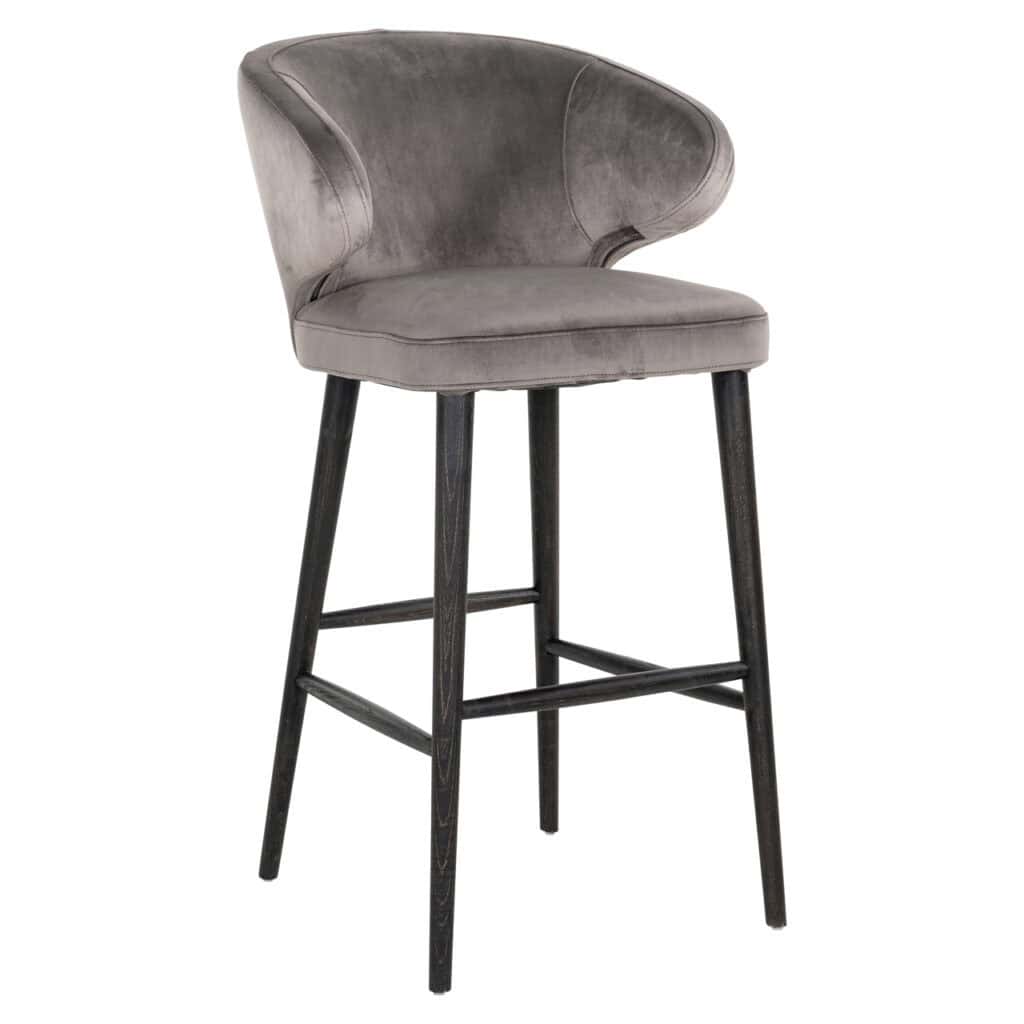 Modern bar stool with gray velvet upholstery and black wooden legs.