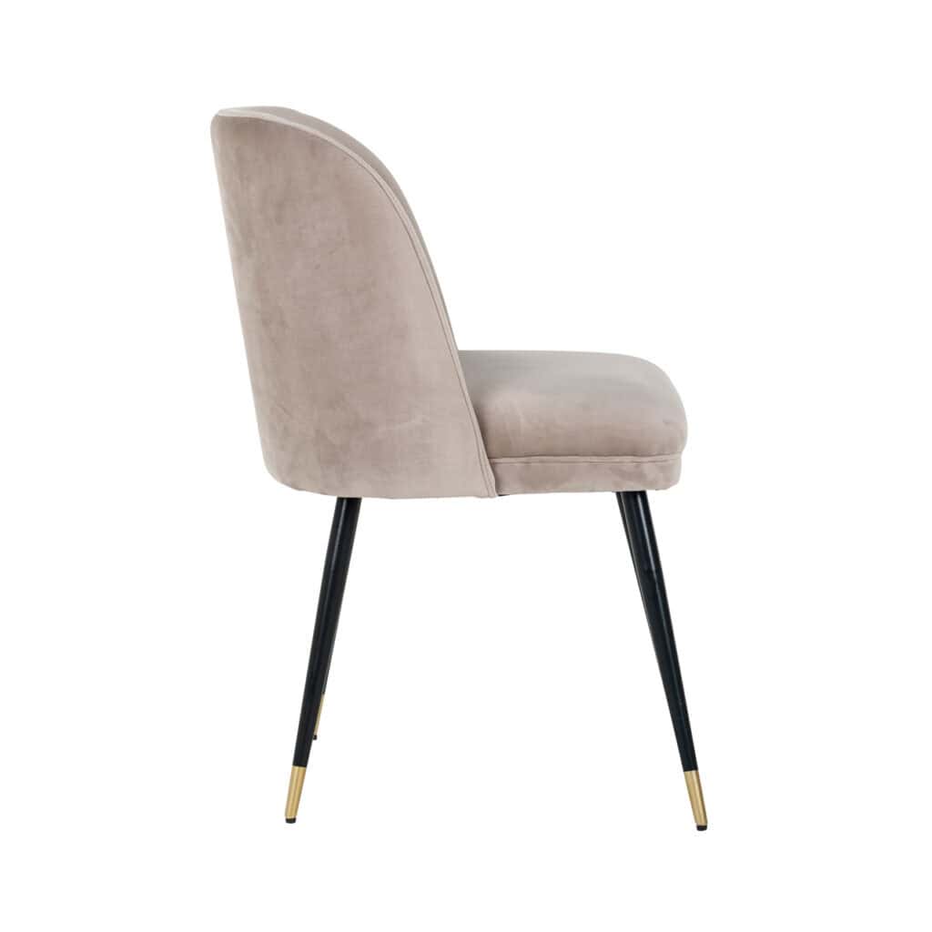 Luxe beige velvet dining chair with black and gold metal legs, modern interior design.
