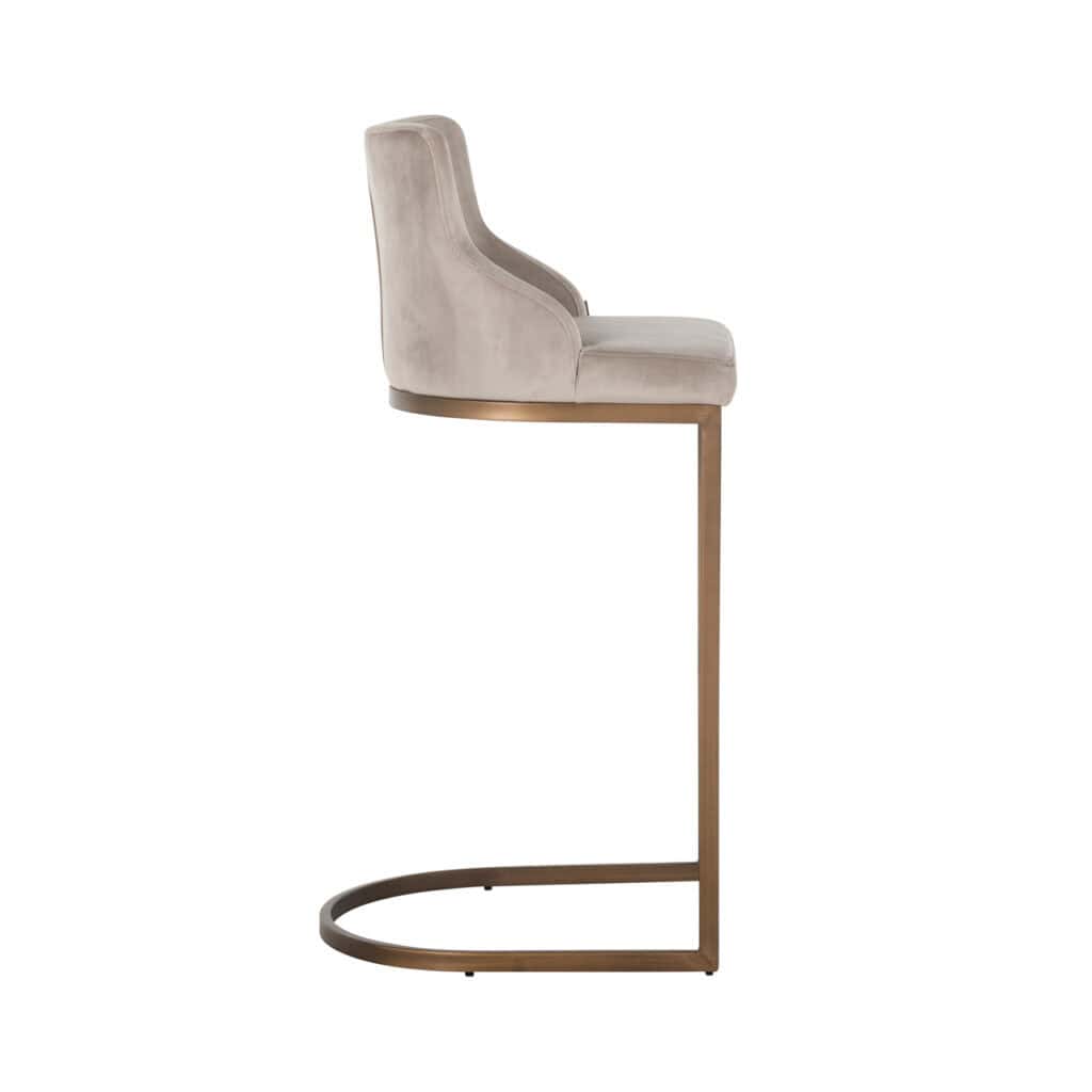 Modern bar stool with beige velvet upholstery and a gold base.