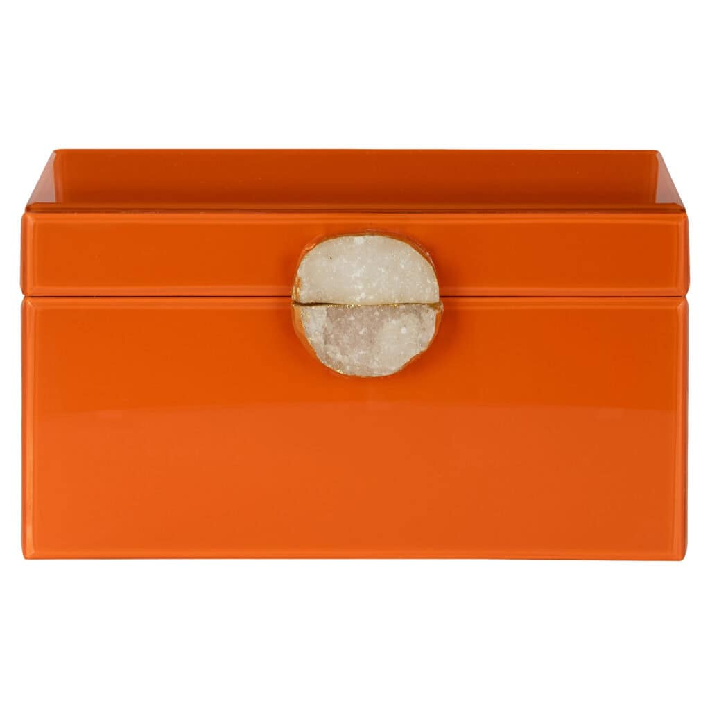 Boîte de rangement orange avec un bouton rond, pour le rangement et la décoration.