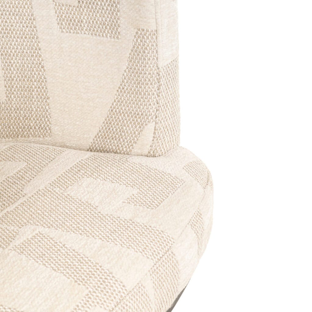 Light beige upholstered chair with a geometric pattern.