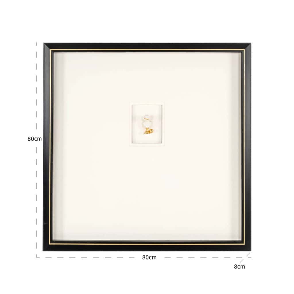 Minimalist black-and-white wall art with gold details in a frame.