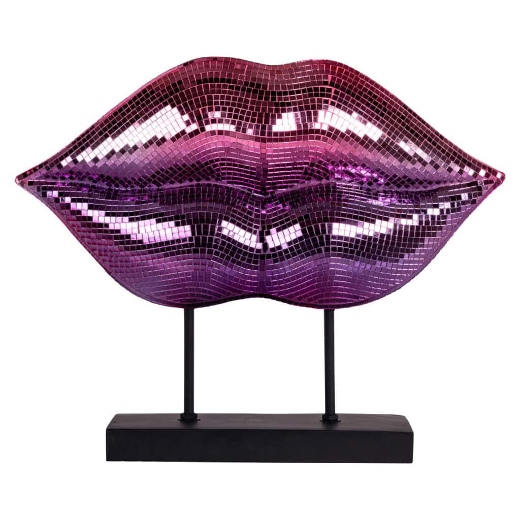 Shiny lip-shaped wall decoration with mirror pieces in pink and purple; a modern interior accessory.