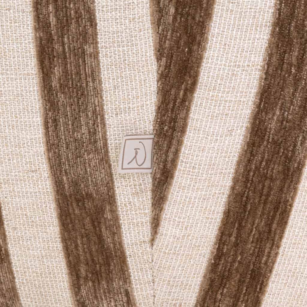 Modern wall decor in earth tones with a subtle logo.