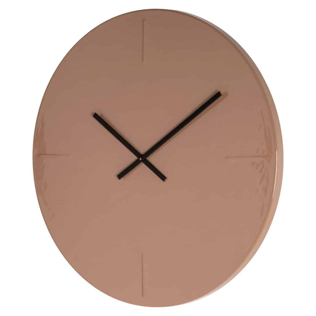 Modern pink wall clock with black hands for stylish interior decoration.