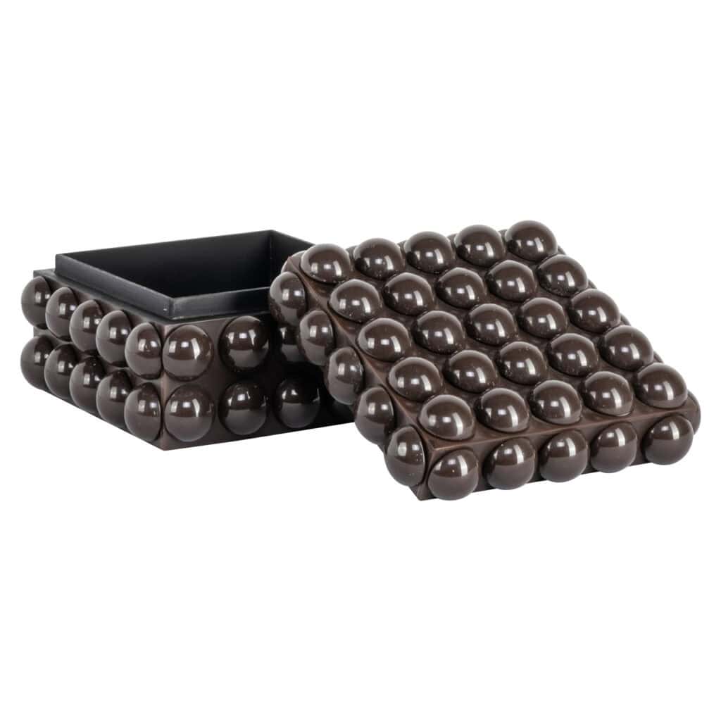 Decoratieve zwarte box met bolvormige details, modern interieuraccessoire.