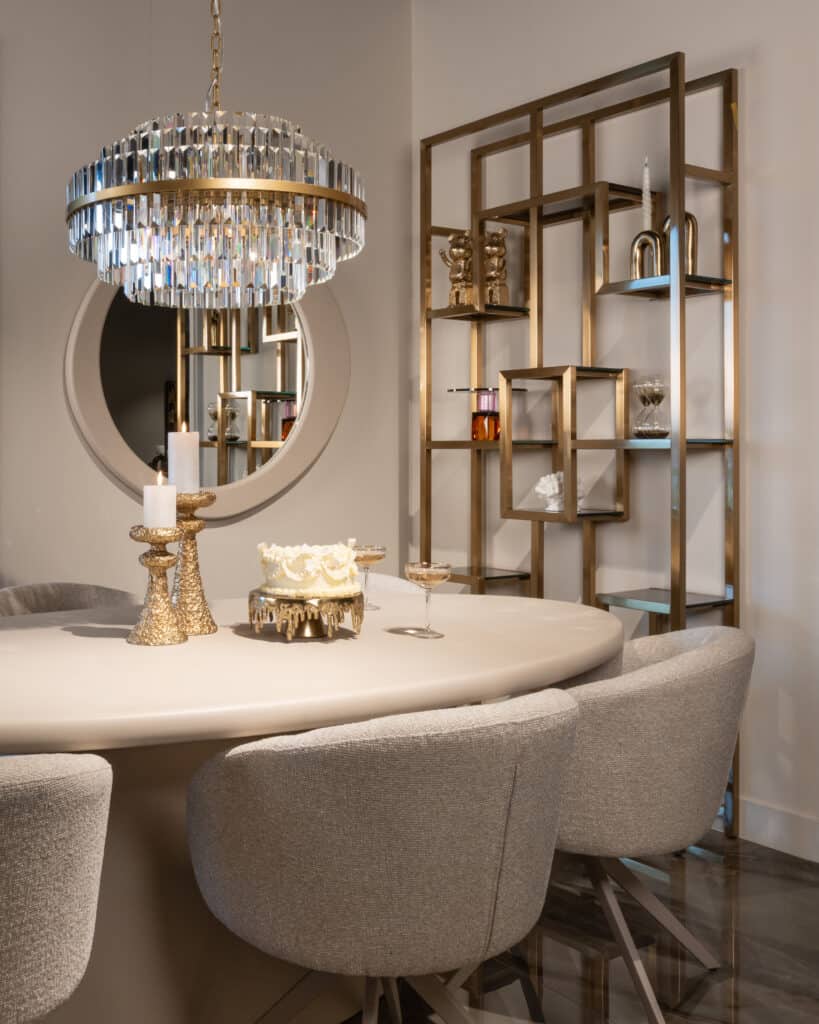 Luxury dining table with a chandelier, decorative Candle holders a modern open-shelf bookcase.