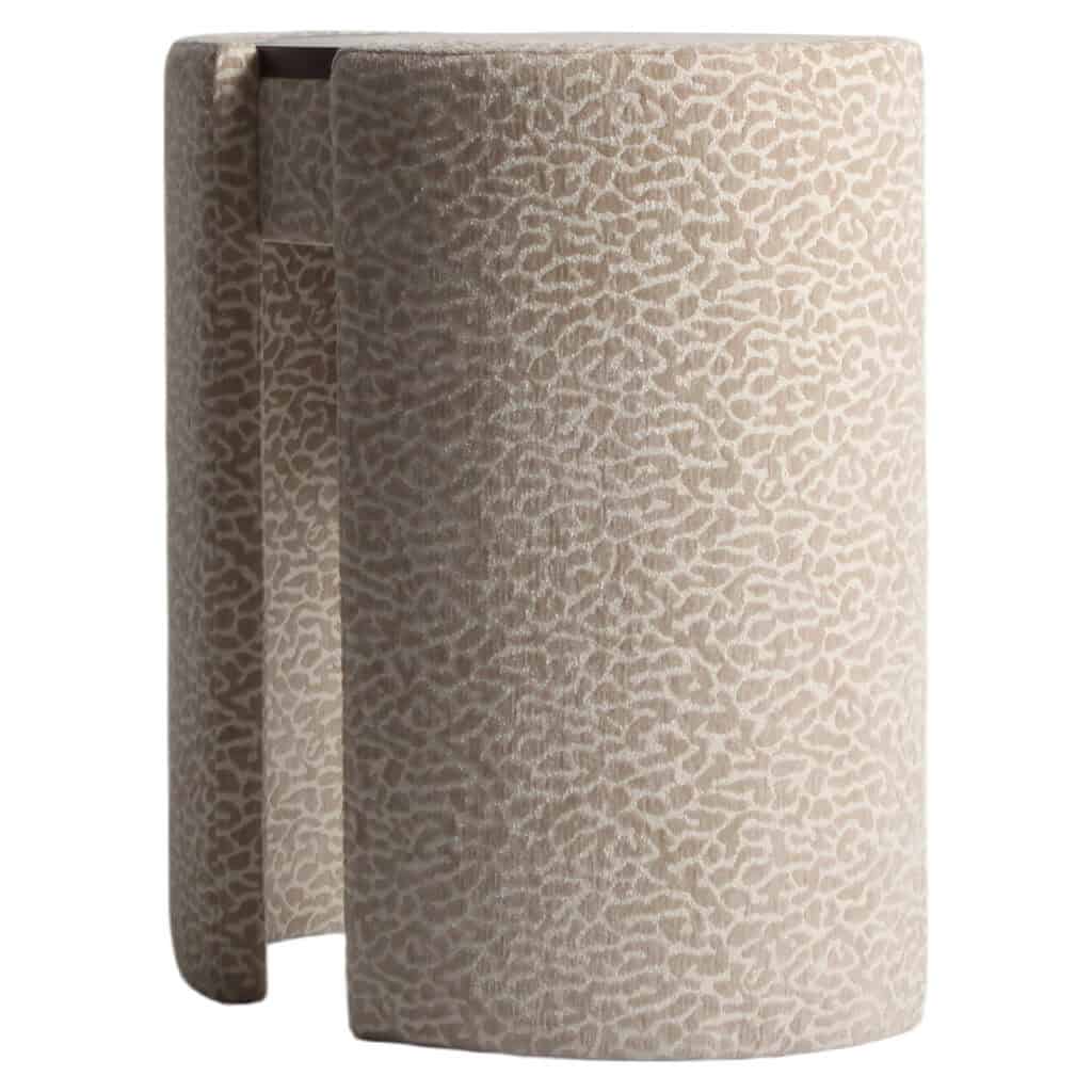 Beige leopard-print dressing table with a rounded shape and a textured pattern.