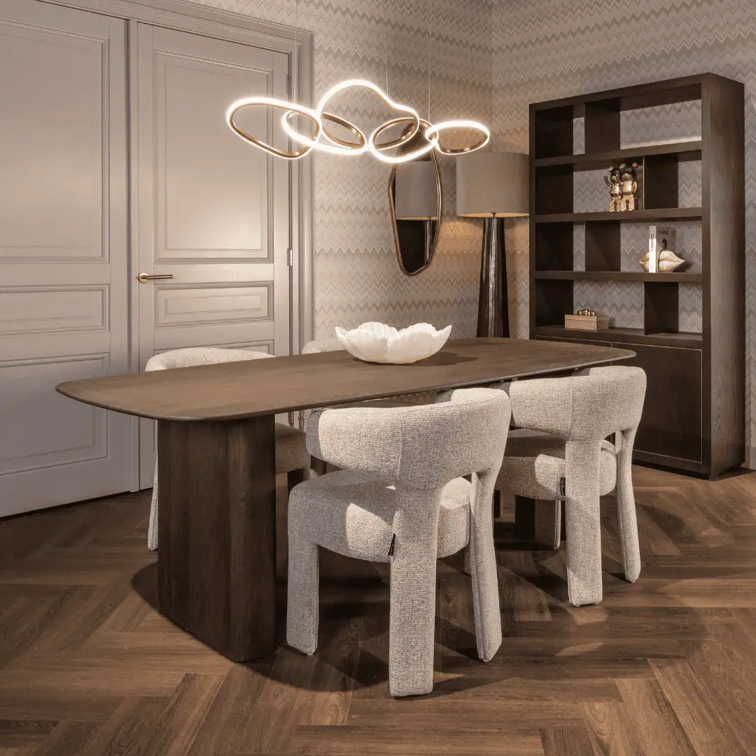 Dining area with modern lighting and stylish furniture at Richmond Interiors.
