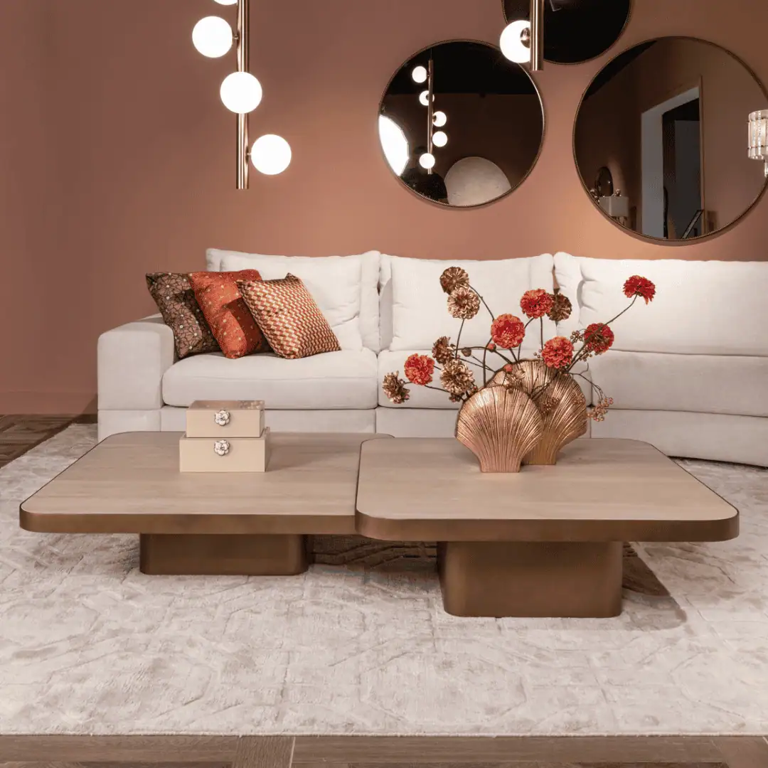 Modern living room with Sofa white Sofa, round mirrors, and a floral arrangement.