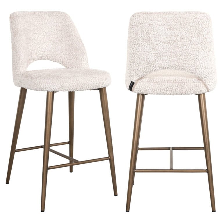 Delphine with soft cream upholstery and wooden legs.