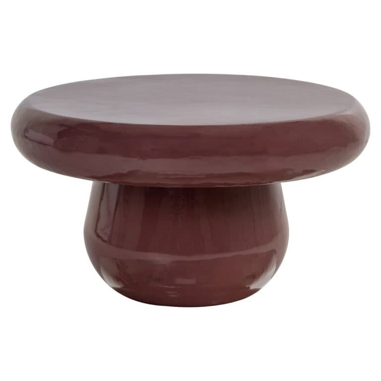 Sable bruine salontafel met ronde vorm en glanzende afwerking.