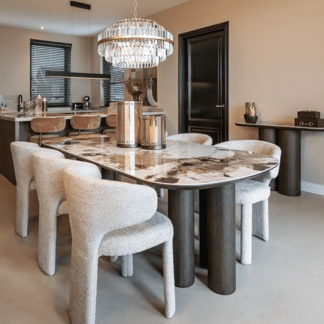 Luxury dining table with a marble top and elegant chairs in a modern interior.