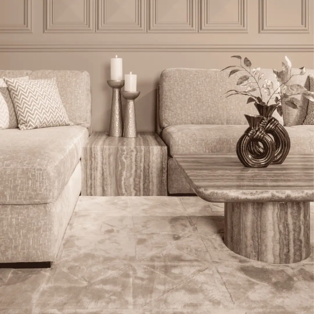An elegant living room with beige sofas and decorative accessories.