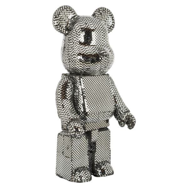 A small, decorative silver bear figurine for home decor.