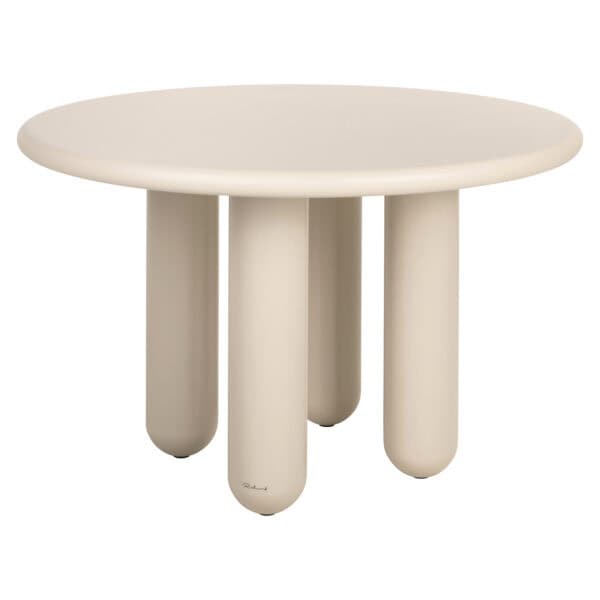Modern beige Calma dining table with a round shape and thick legs.