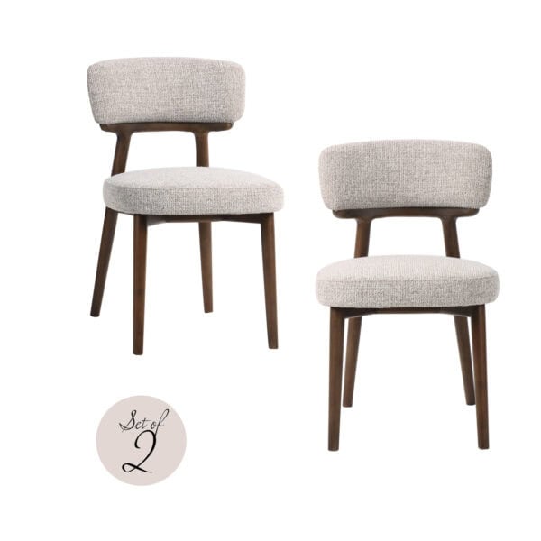 Set of two Basker dining chairs with wooden legs and light-colored upholstery.